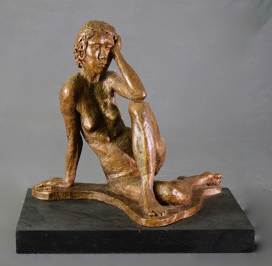 Seated female leaning left arm on left leg in cast resin by William Casper.