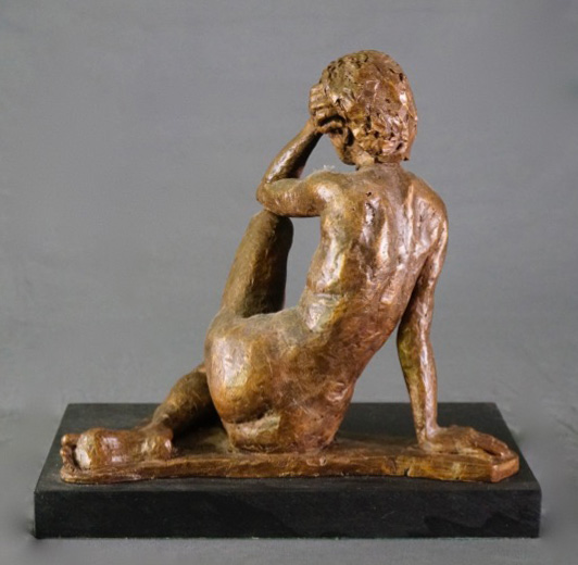Seated female leaning left arm on left leg rear view in cast resin by William Casper.