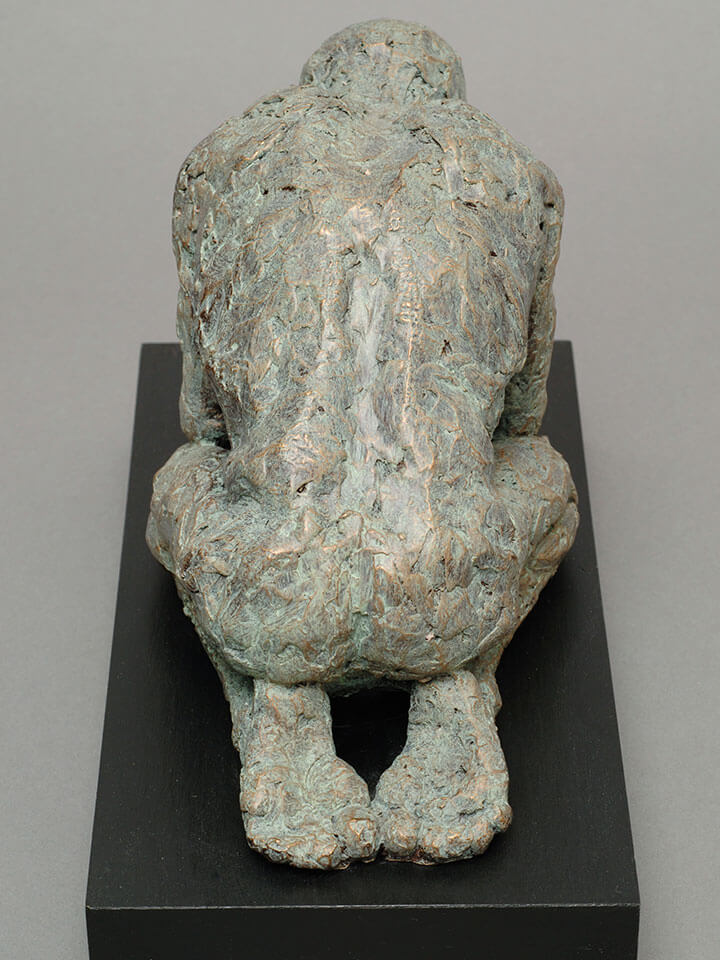 Kneeling and supplicating male figure rear view in cast resin by William Casper.