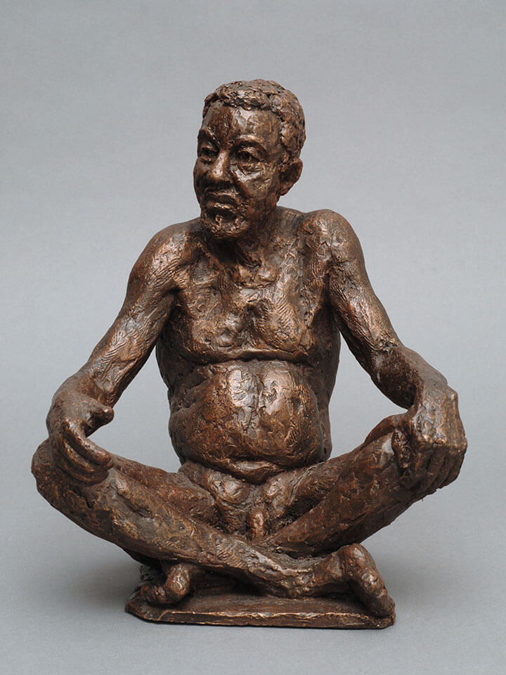 Mature male sitting cross legged with hands on knees in cast resin by William Casper